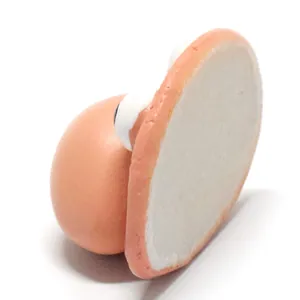 Close-up showing the flat white back surface of a cute resin gnome face craft accessory