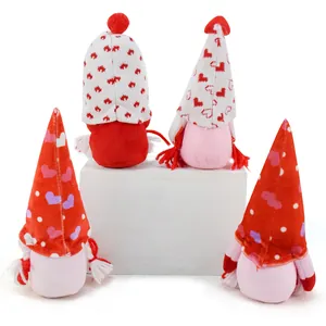 Four cute Valentine's Day faceless gnomes with heart-patterned hats on a white pedestal.