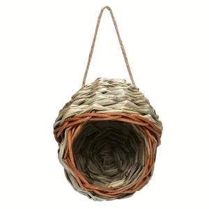 Detailed view of a natural hand-woven straw bird nest perfect for outdoor garden use