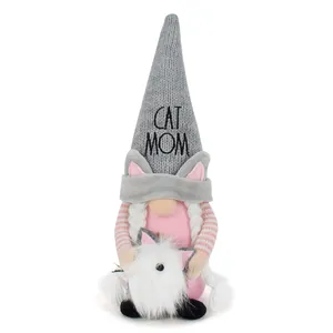 Close-up detail of a cat-themed plush gnome doll with 'CAT MOM' embroidered on the hat