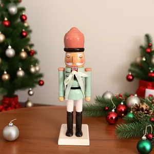 Close-up of a 25cm mint green wooden nutcracker soldier in a Christmas setting.