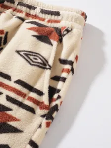 Close-up detail of warm fleece-lined men's pants with ethnic tribal geometric pattern