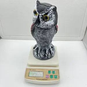 Realistic rotating owl decoy bird deterrent on scale showing its total weight detail