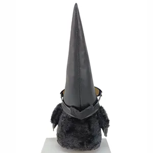 Detail view of a black faux leather gnome doll with sunglasses on its head