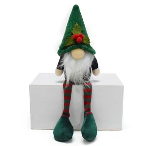 Detailed close-up of a festive sitting Christmas gnome plush with long red and green striped legs