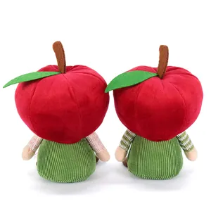 Macro view of the back of two apple plush gnomes with corduroy and striped sleeves