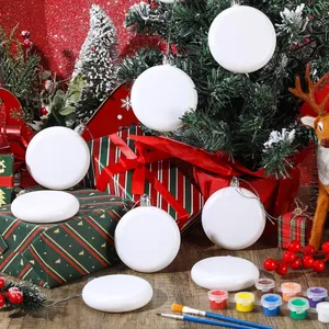 Blank white round Christmas ornaments for DIY painting with festive props