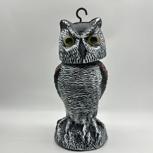 Detailed view of a realistic owl decoy with an S-hook for effective bird scaring outdoors.