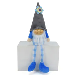 Close-up of cute gnome doll with resin face and blue plaid hanging legs