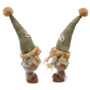 Detailed view of handmade Nordic forest gnome plush dolls with tall knitted hats and fur trim