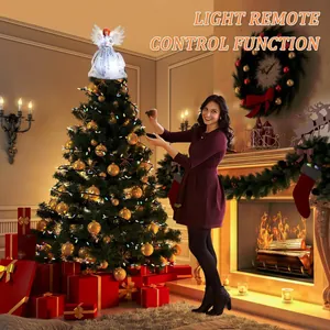 Glowing angel Christmas tree topper decoration being controlled by a remote in a home