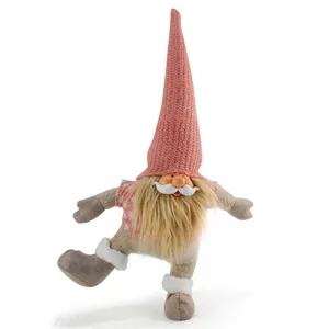 Detailed view of a charming dancing Christmas gnome figurine with a long pink knit hat