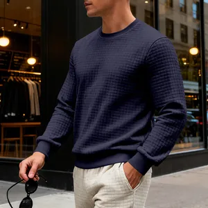 Close-up of men's navy blue crew neck sweatshirt featuring a modern quilted square texture.