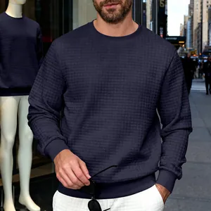 Close-up of men's navy waffle knit crewneck sweatshirt showing fine square texture fabric.