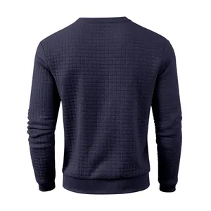 Detail view of navy blue crewneck sweatshirt featuring a textured quilted grid pattern