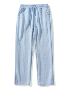Close-up view of light blue cable knit casual trousers with drawstring and side pockets
