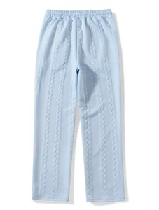 Detail view of light blue cable-knit trousers with elastic waistband and soft texture.
