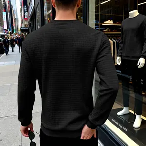 Back view of men's black crewneck sweatshirt featuring a textured small grid pattern