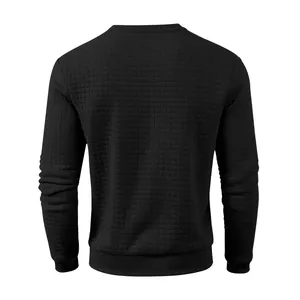 Detail view of the back of a men's black pullover with a waffle square texture finish
