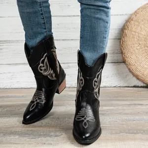 Women's black cowboy boots featuring intricate embroidery, pointed toe, and chunky heels.