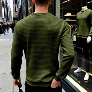Back view of olive green men's waffle knit crewneck sweatshirt in city street