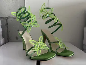 Elegante grüne Wickelsandalen mit Strasssteinen und Schmetterlingsdetail, Karree-Design.