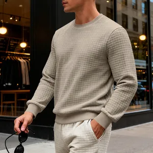 Detail of men's beige checkered texture long-sleeve sweatshirt in urban street setting