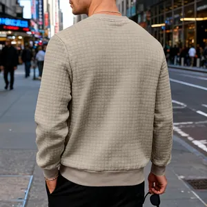 Close-up detail showing the waffle grid texture on the back of a men's beige crewneck sweatshirt