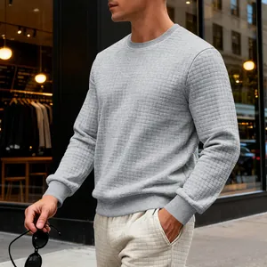 Detailed view of men's grey sweatshirt featuring small square waffle texture and crew neck.