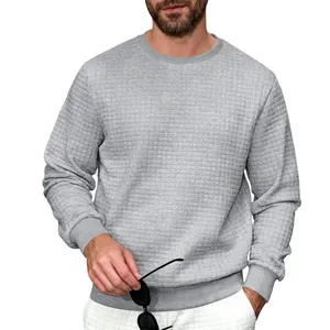 Detail of a gray men's sweatshirt featuring a quilted waffle texture and crew neck.