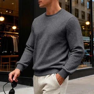 Detail of grey men's crewneck sweatshirt featuring a unique grid textured fabric