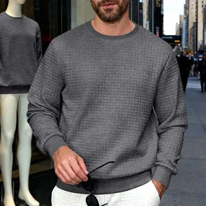 Close-up of men's grey crewneck sweatshirt with fine quilted texture in urban setting