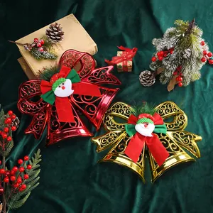 Pair of festive Christmas bells in red and gold with Santa Claus and bow accents.