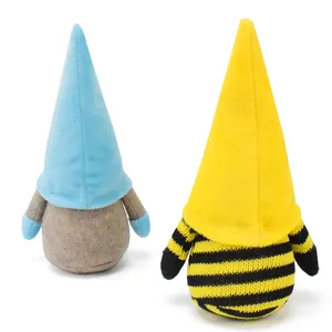 Detailed back view of handmade faceless gnome plush dolls in blue and bee stripe styles