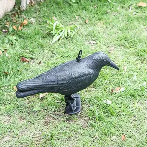 Macro view of a realistic black crow decoy used for hunting bait and garden bird repellent