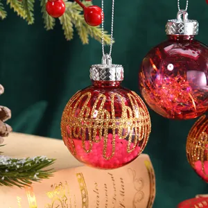 Festive red Christmas baubles with gold glitter grid patterns for tree decoration.