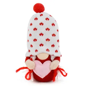 Detailed close-up of Valentine's Day plush gnome doll holding a soft pink heart.