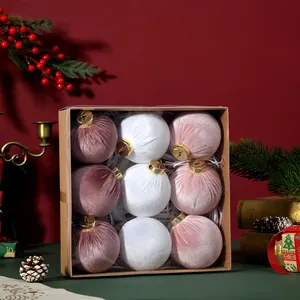 Assorted velvet Christmas ball ornaments in soft pink and white tones.