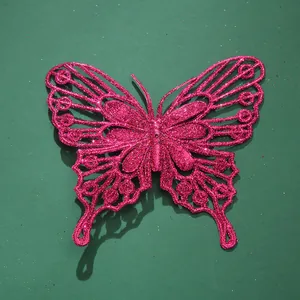 Primo piano di una vivace decorazione a farfalla rosa glitterata con design traforato unico.
