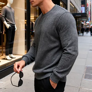 Close-up detail of a men's grey crewneck sweatshirt featuring a textured grid pattern.