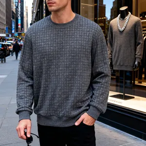 Detail view of men's grey waffle knit sweatshirt with square grid texture on model.