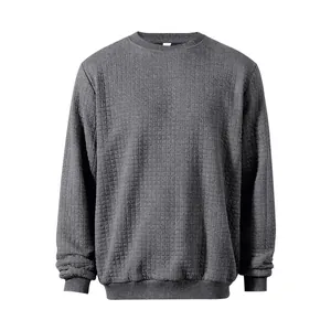 Detailed view of men's grey crew neck sweatshirt with unique small square waffle texture