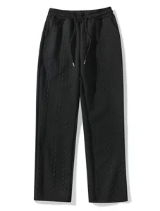 Detailed view of men's stylish black cable knit joggers with textured jacquard pattern