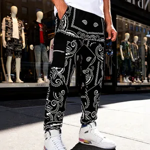 Detailed view of men's black paisley bandana print cargo pants on model in street setting