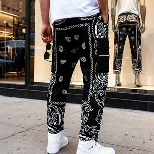 Rear view detail of men's high street black paisley print cargo pants in urban setting