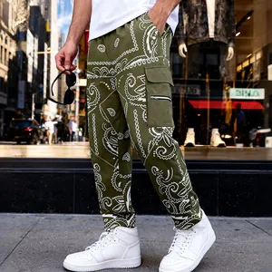 Detailed view of olive green cargo pants with white paisley print and side pockets
