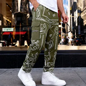 Side view of olive green paisley cargo pants with pocket and zipper detail on street