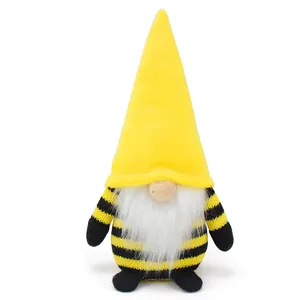 Detailed view of a handmade bee-themed gnome plush with tall yellow hat and striped body
