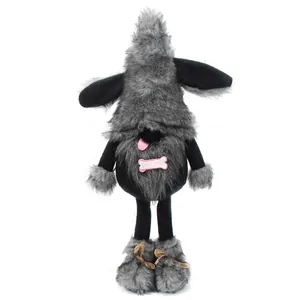 Detail view of dog-themed gnome doll with grey and black plush fur and pink bone