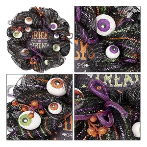 Halloween door wreath with spooky glowing eyeballs and Trick or Treat sign decoration